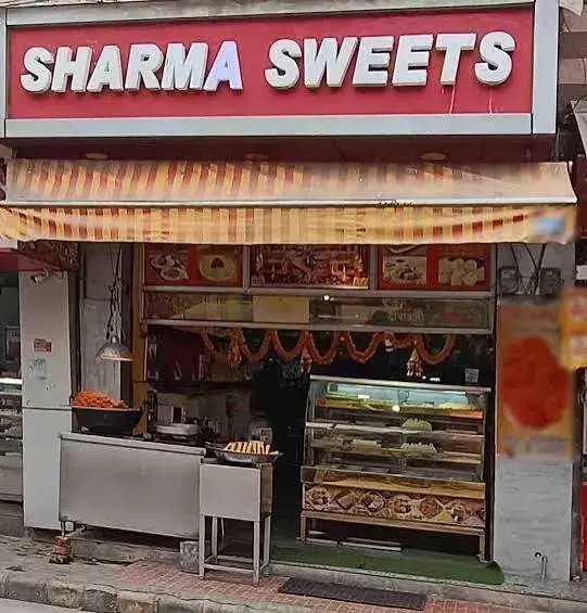 Storefront of Sharma Sweets & Restaurant on Main Road, Makronia